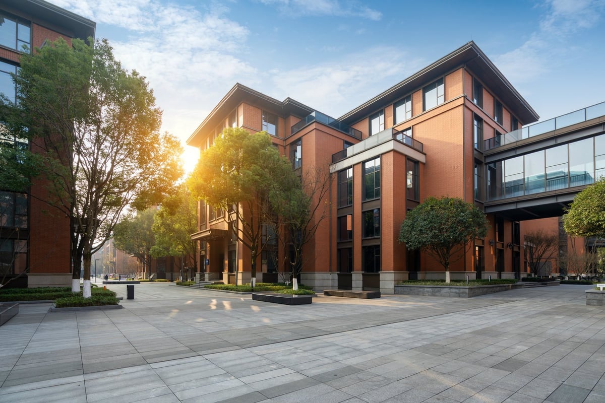Brick commercial office building surrounded by trees